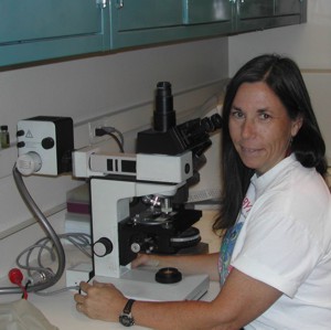 Lynn at her microscope, ca. 1990