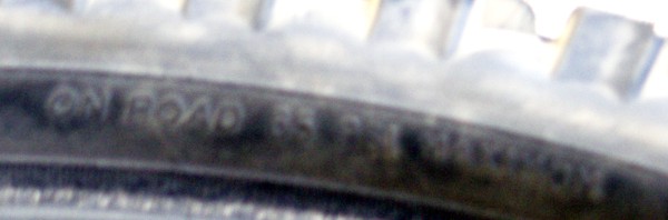 Tire sidewall showing pressure widths, including 65 max on-road