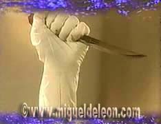Gloved hand with a knife