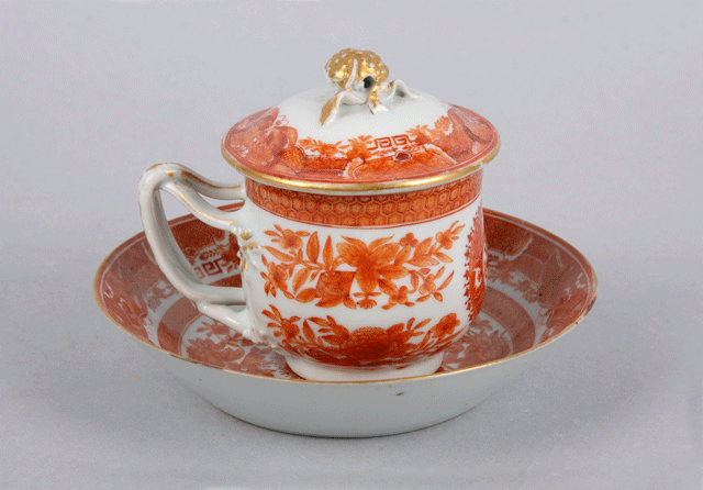 covered tea cup and saucer