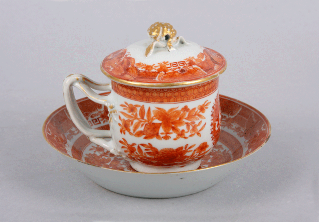 Covered tea cup and saucer